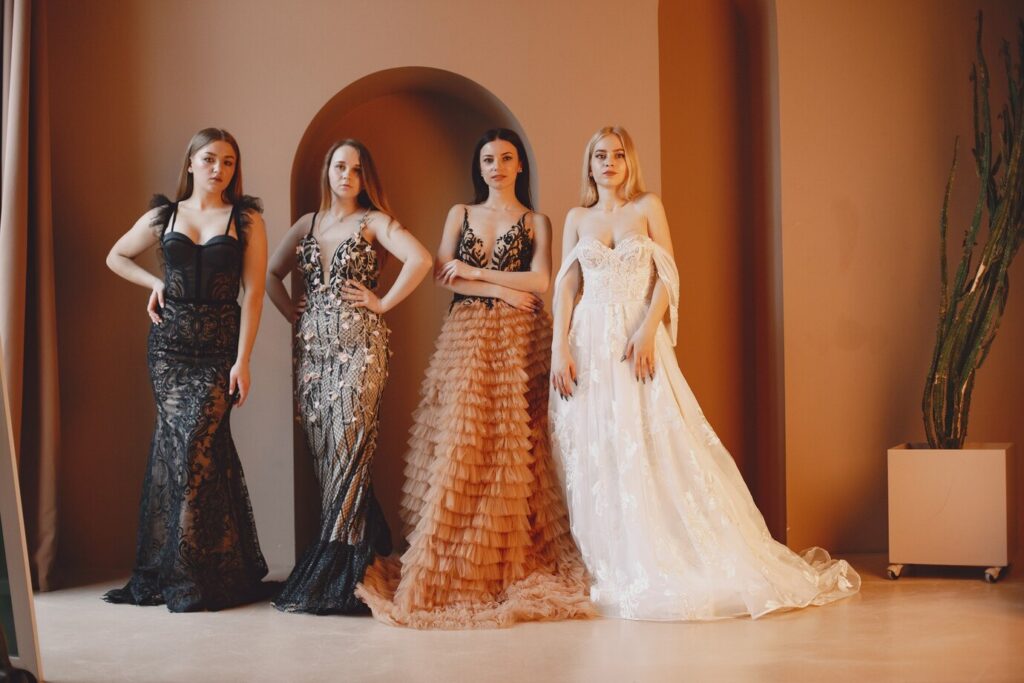 women showcase elegant gowns