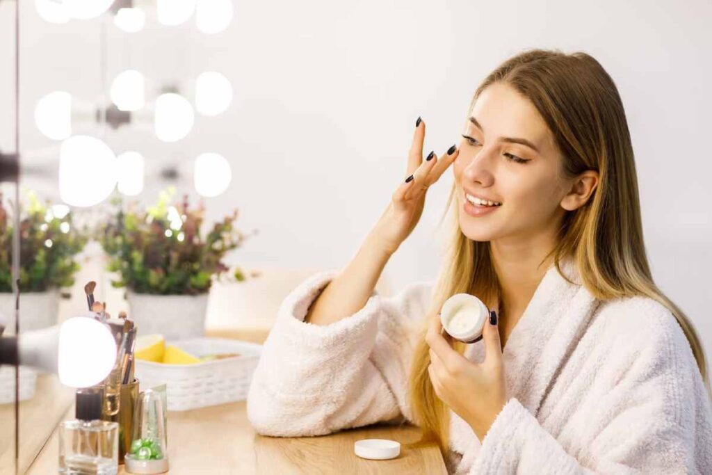 beautiful blonde girl cares for face skin